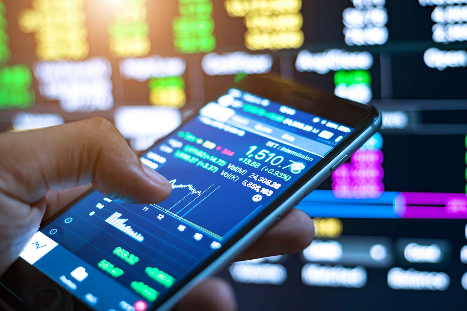 Cropped Image of Man Checking Stock Market on Mobile Phone