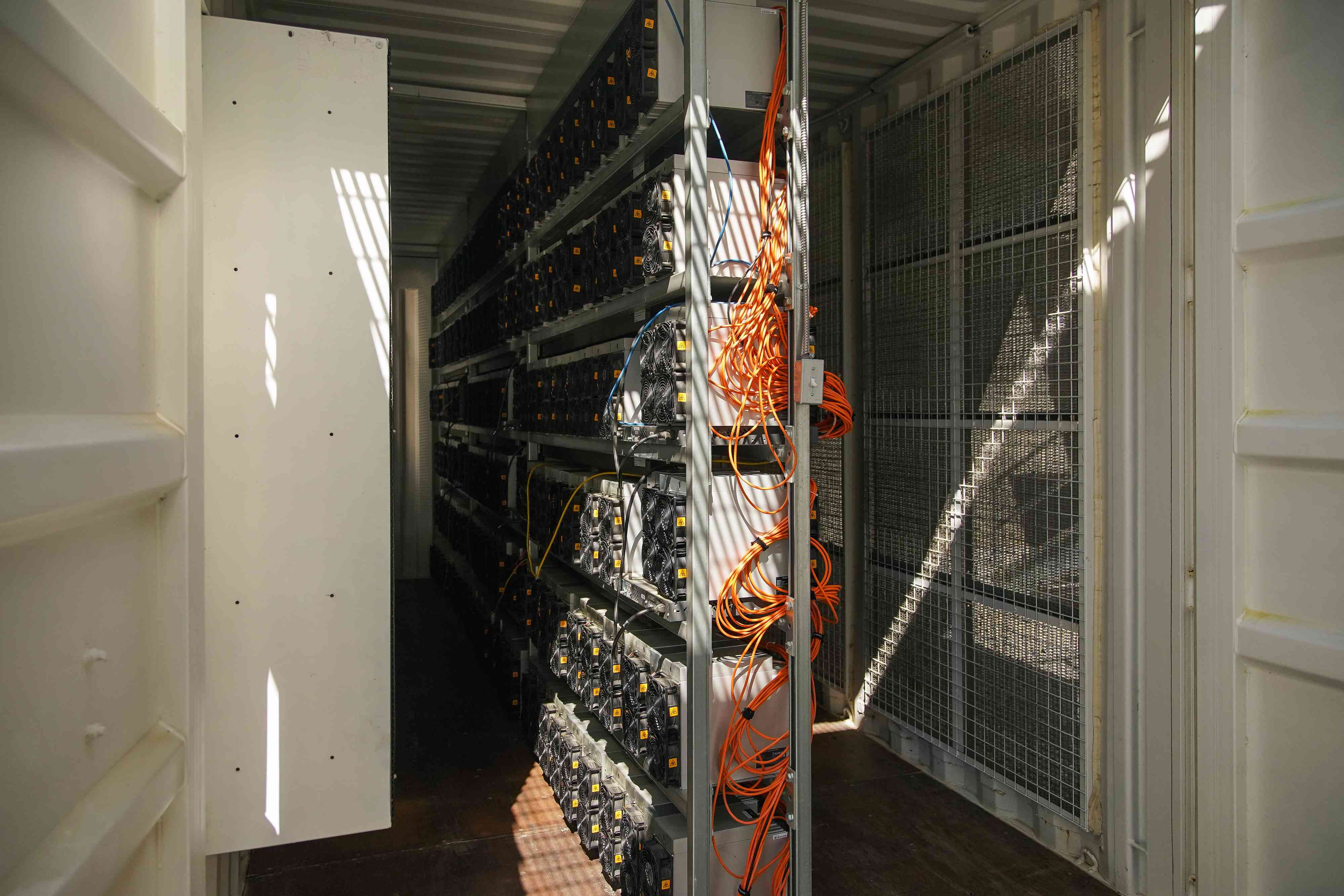 A row of bitcoin mining units are pictured inside a container at a CleanSpark facility