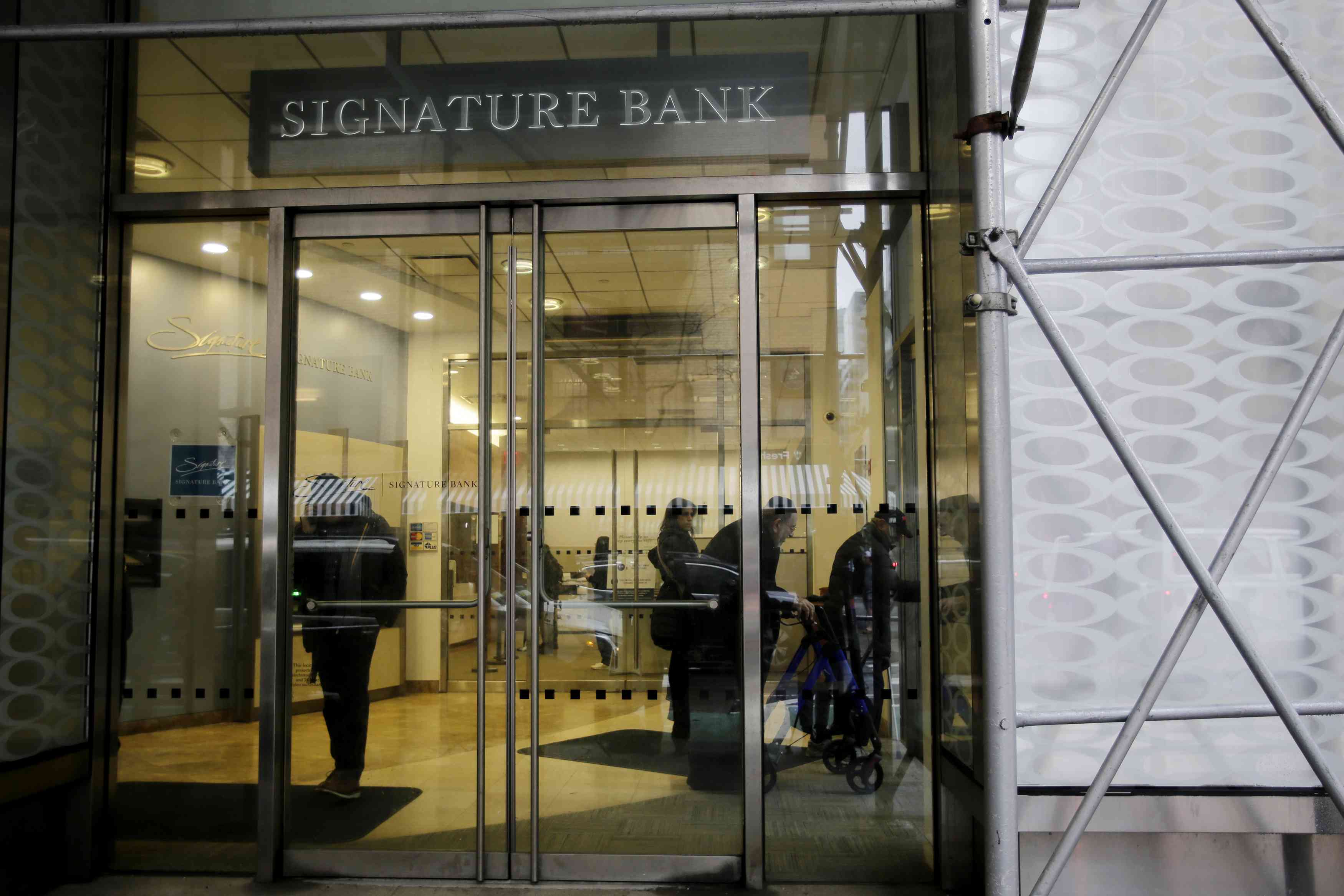 People wait inside the Signature Bank branch in New York City on March 13, 2023. Signature Bank, a $110 billion commercial bank with offices in California, Connecticut, Nevada, New York, and North Carolina, was closed by regulators on March 12, 2023. Customers alarmed by the failure of Silicon Valley Bank yanked their funds.