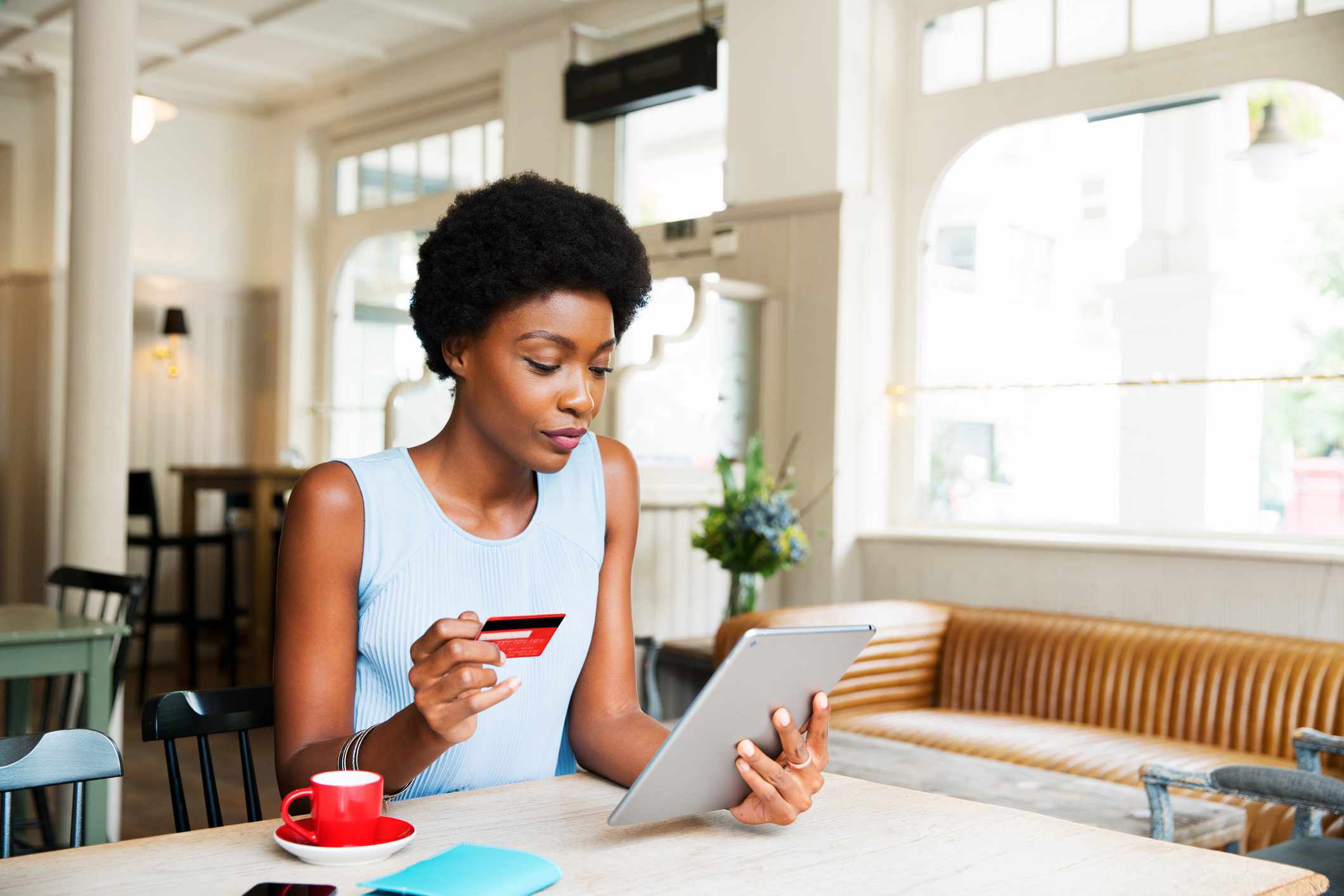 Woman with credit card and tablet